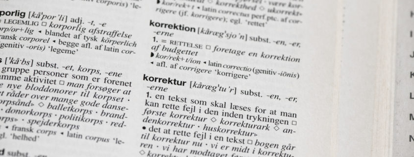 Et close-up af ordet korrektur fra Nudansk Ordbog